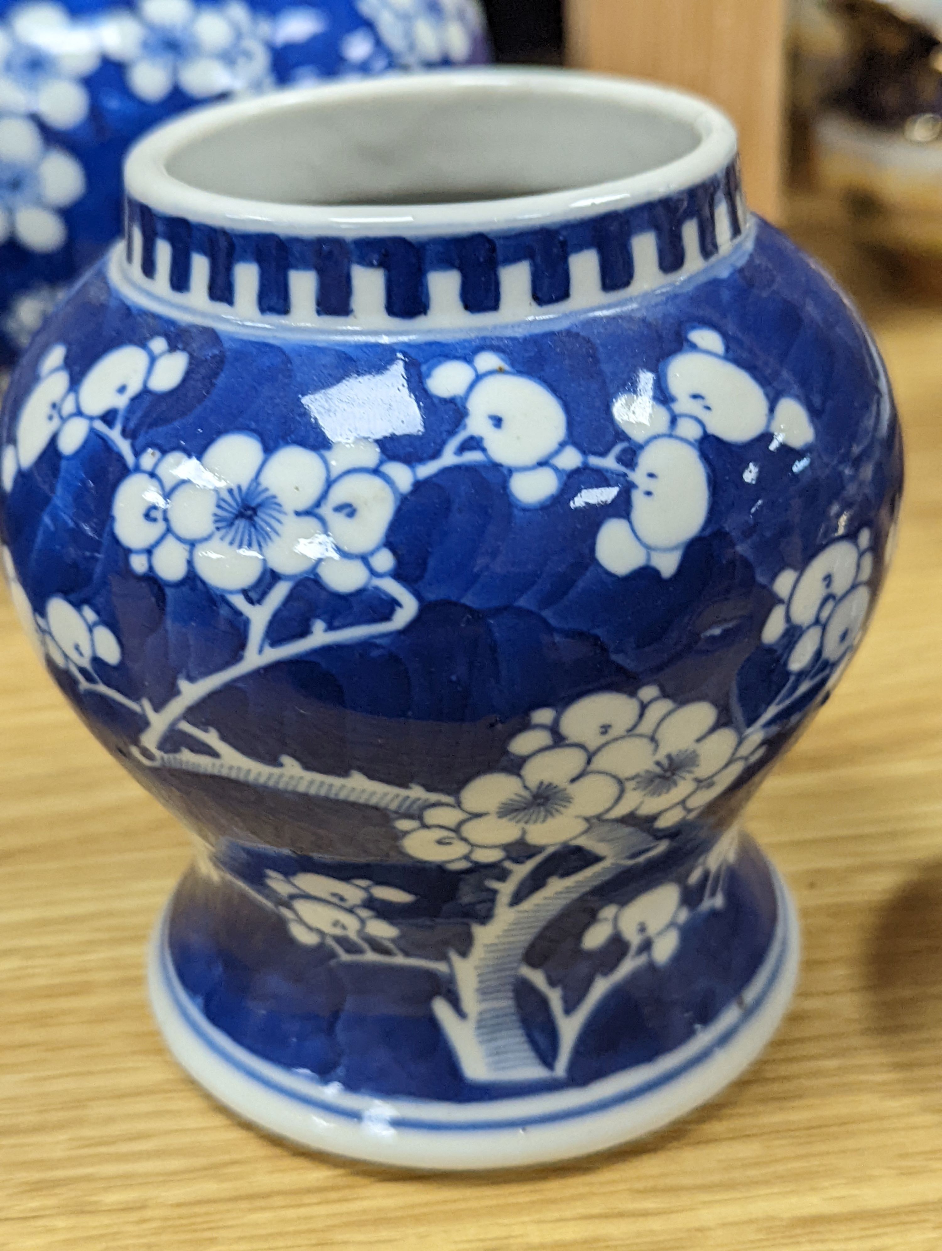 Three Chinese blue and white prunus decorated jars and covers, 19th/20th century, with four character marks 18cm